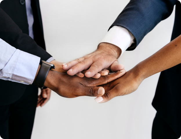 A diverse group joining hands in partnership