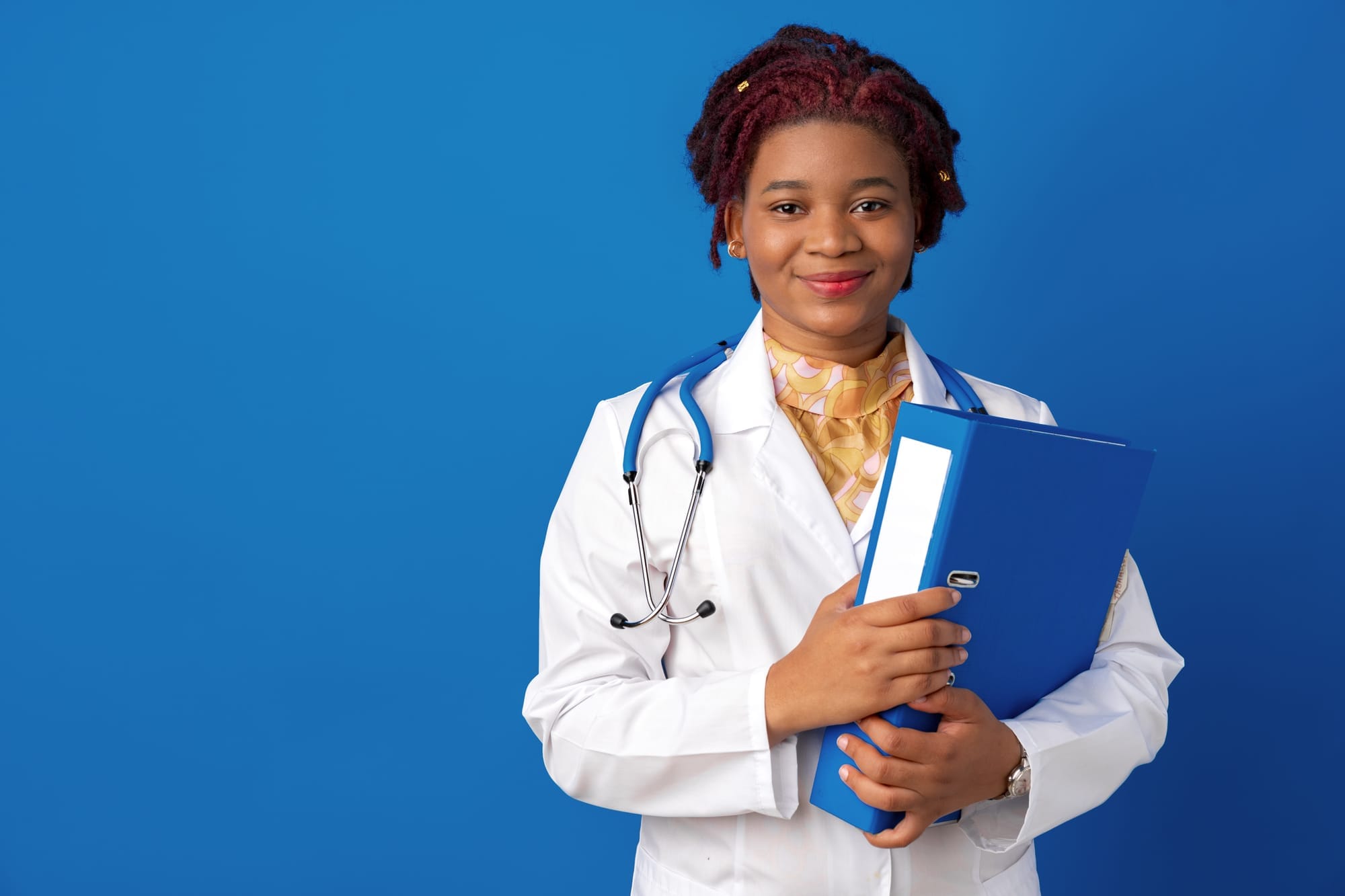 A clinician holding a blue folder